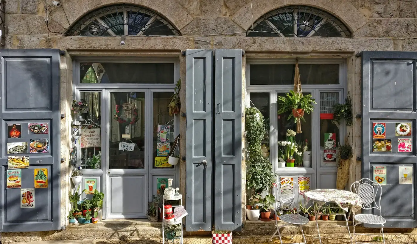Gevel van Broodjesbar Korrel & Kruim met planten, een bistrotafeltje en stoeltjes voor de deur